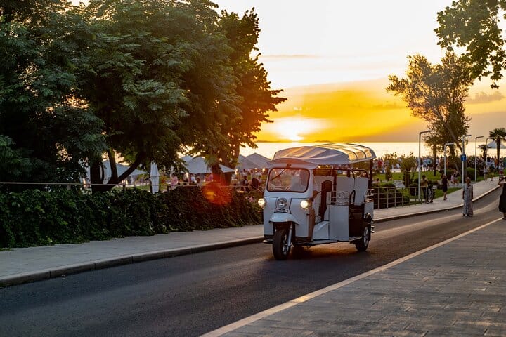 Eco tuk tuk vehicle approaching during sunset in Zadar, Croatia