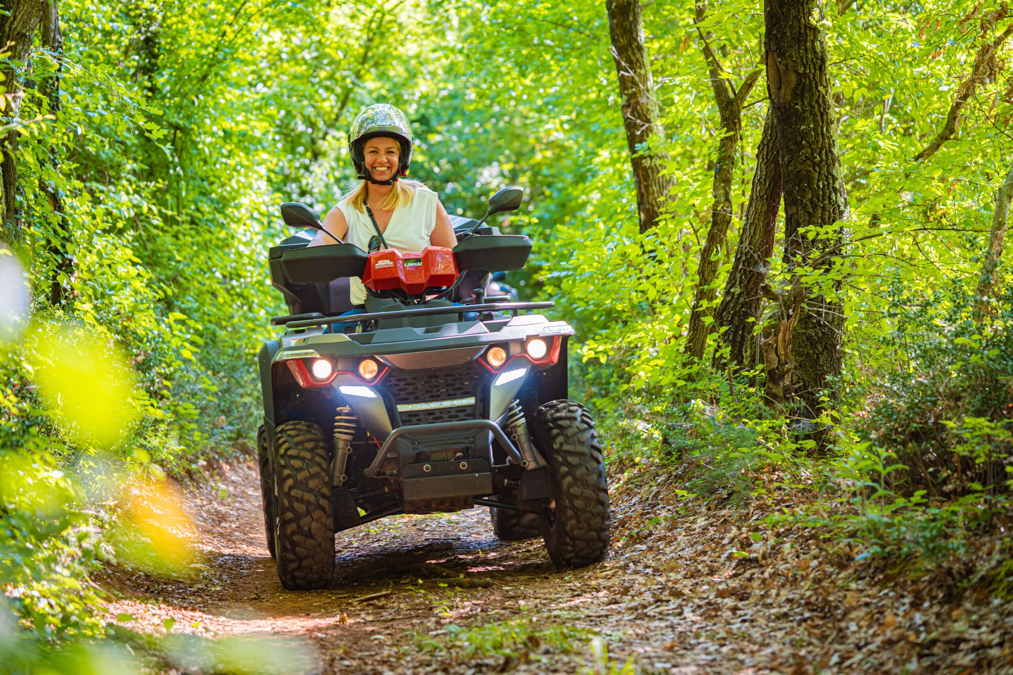 Cura plave kose vozi se na quad bikeu šumama Istre