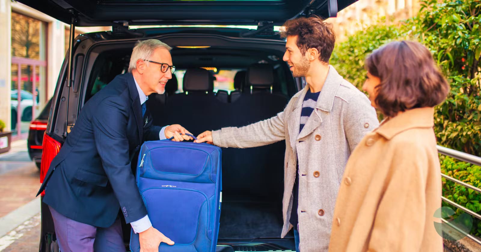 Trend Auto Zadar driver taking out passenger's luggage from the van